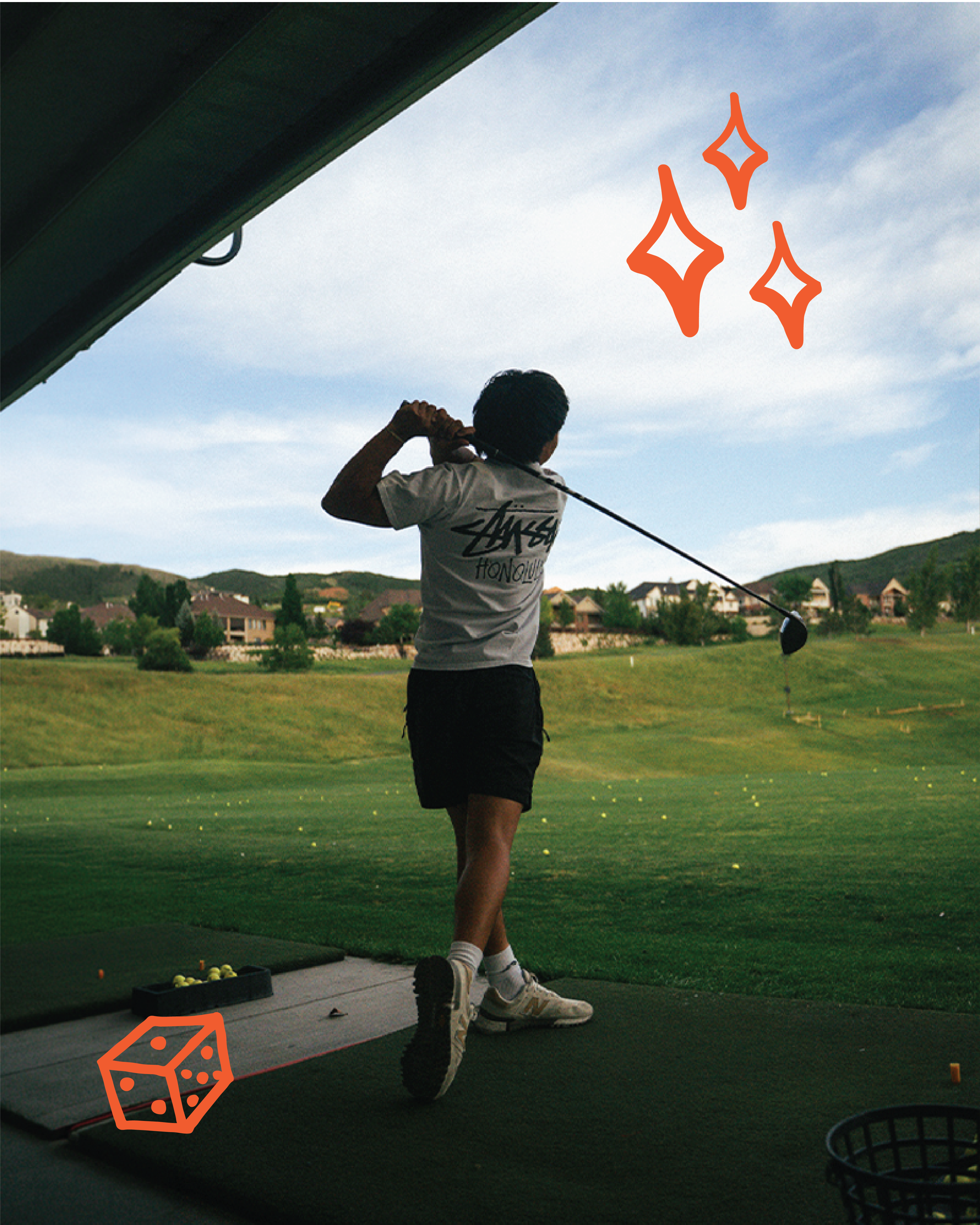 A person in a white shirt and black shorts swings a golf club at a driving range, seen from behind. Green hills with houses and a blue sky are in the background. Orange star and dice graphics are superimposed.