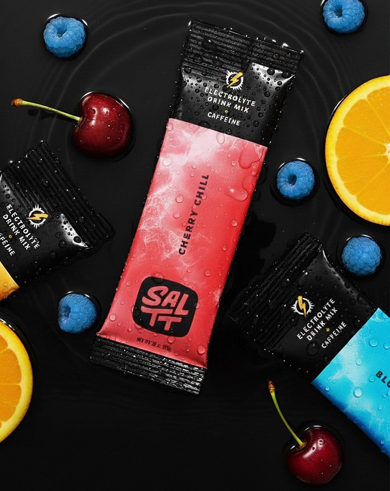 SALTT Cherry Chill Electrolyte Drink Mix + Caffeine single-serve stick pack, red with an ocean splash pattern and black ends, covered in water droplets.