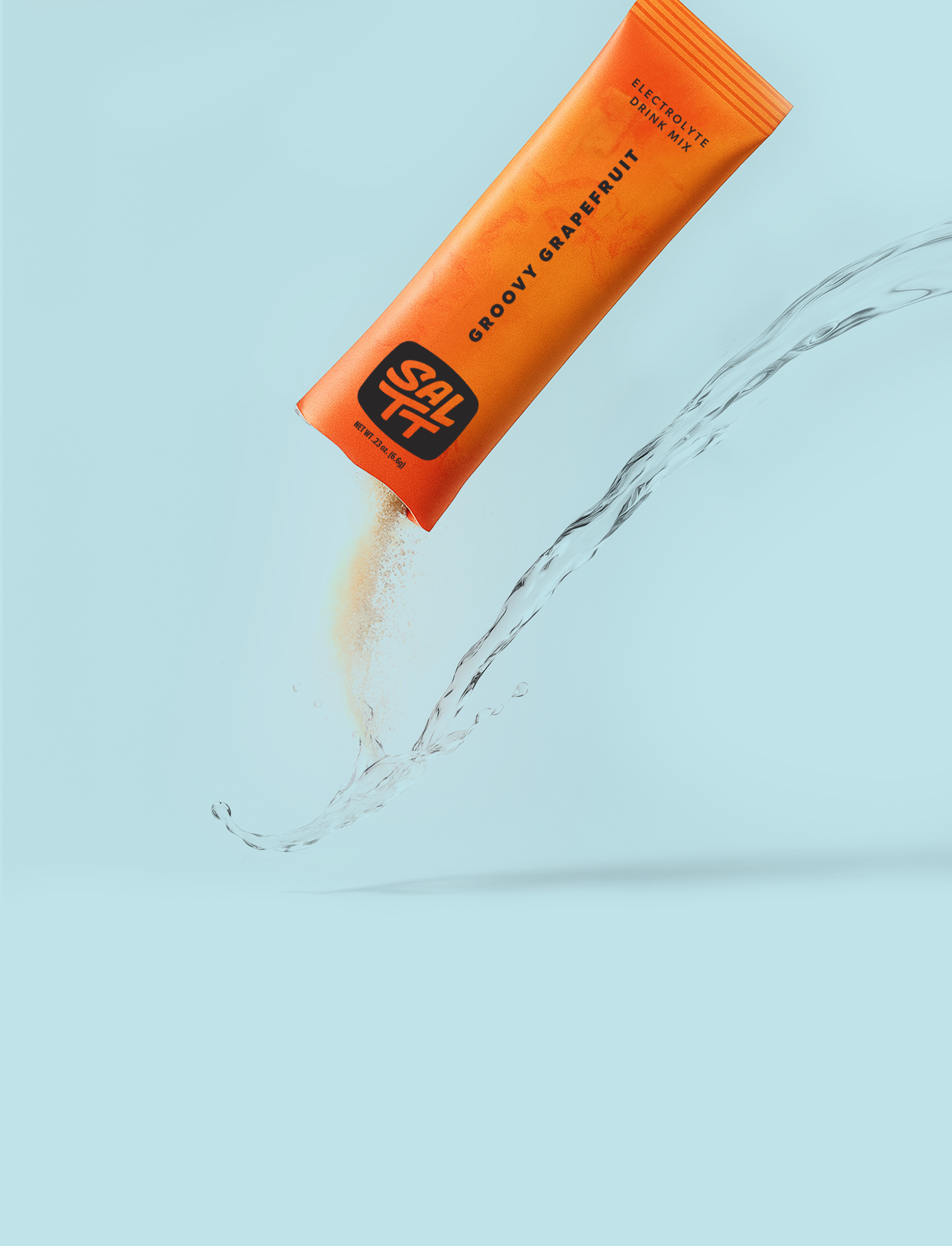 SALTT Groovy Grapefruit drink mix packet being poured into water on a light blue background