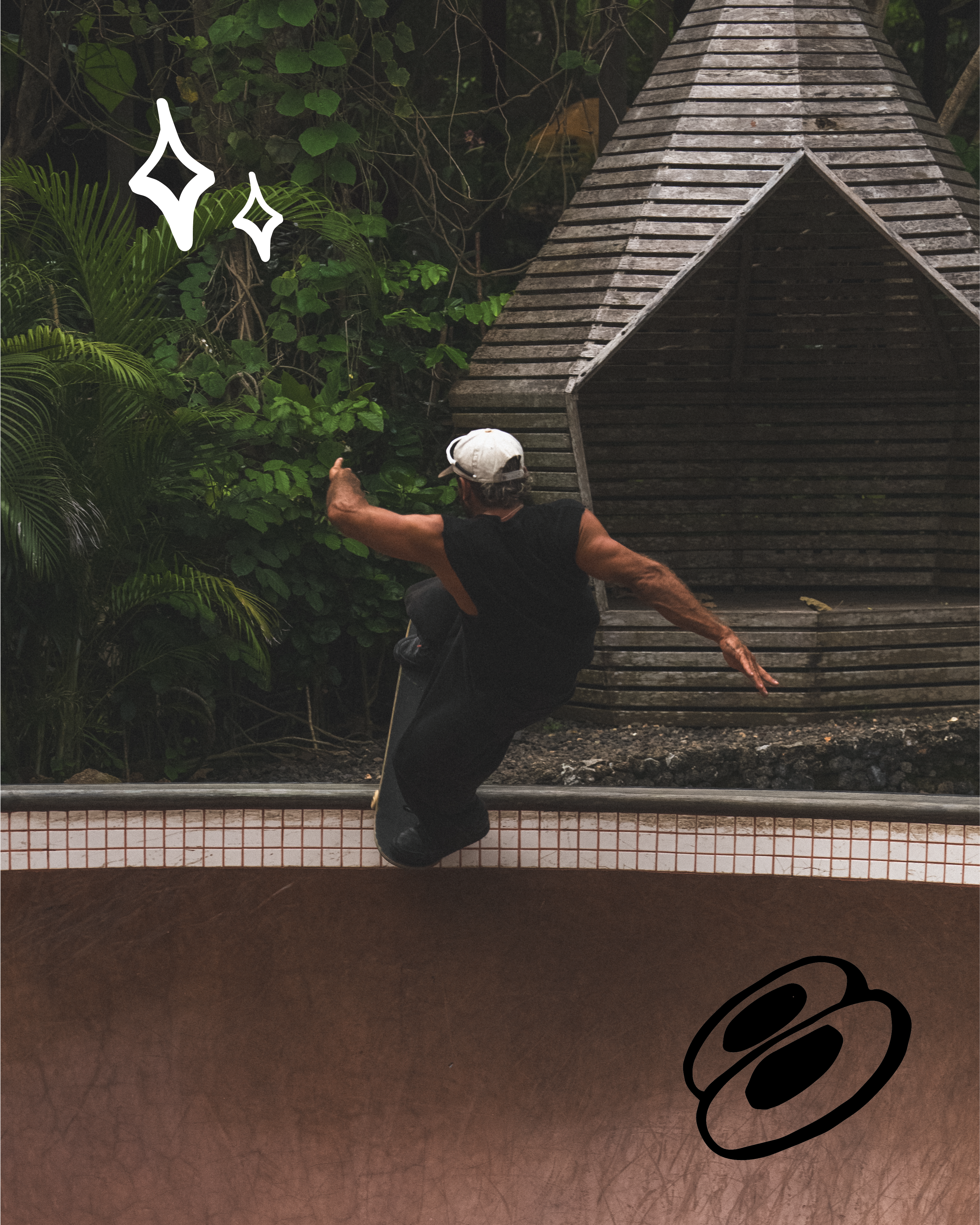 Skater in white cap and black clothes in a brown skate bowl. Green plants and a wooden structure are behind. White spark and black oval graphics.
