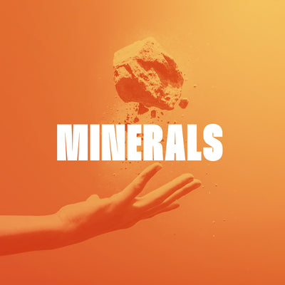 Large white text MINERALS centered on an orange background, with a rough orange rock floating above and an orange hand reaching from below.