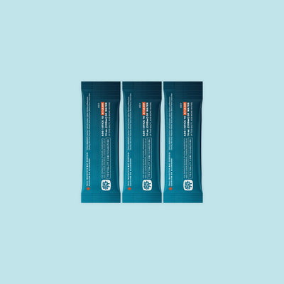 Three teal SALTT stick-pack pouches featuring a light blue ocean water splash graphic and white text for brand and product information.