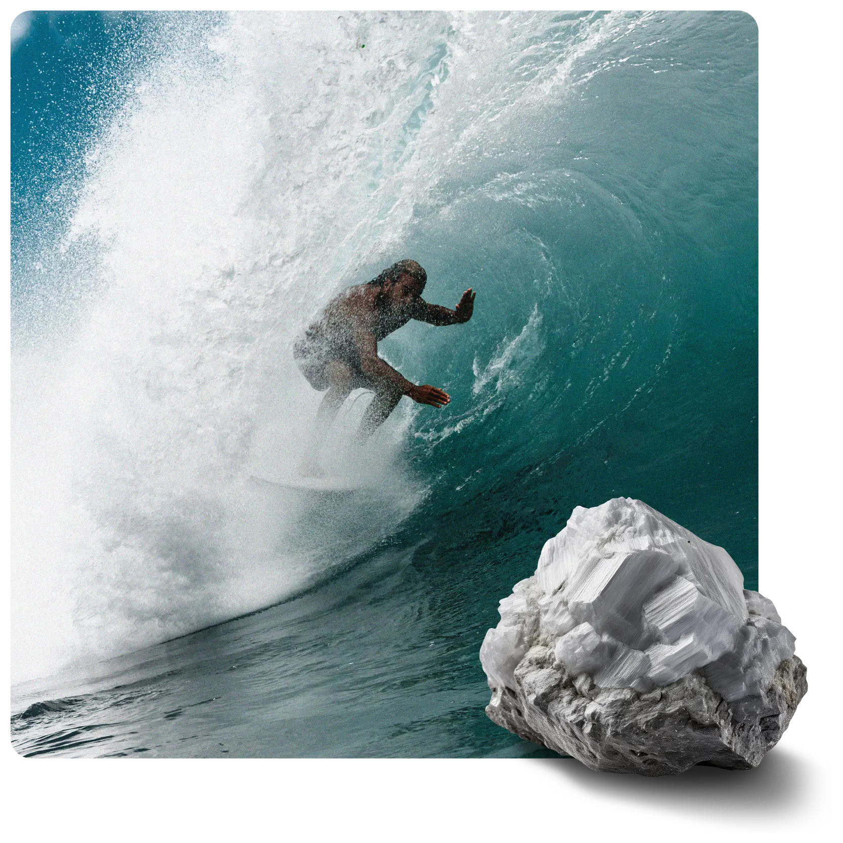 A surfer rides inside a large blue-green ocean wave. A white crystalline mineral rock is in the bottom right corner.