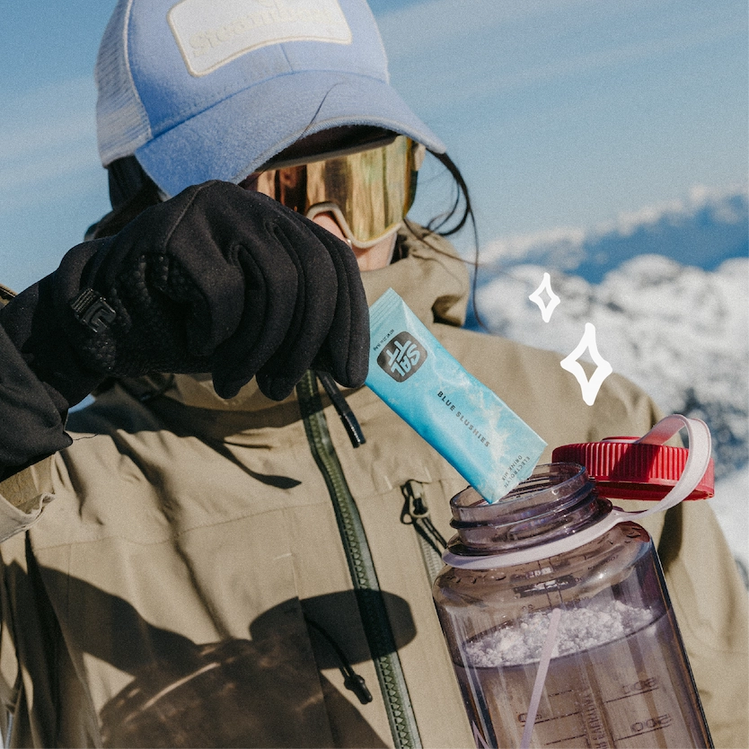 SALTT Blue Slushies electrolyte single-serve stick pack, blue with a white ocean splash pattern. Contains electrolytes, zero sugars, dyes, citric acid.